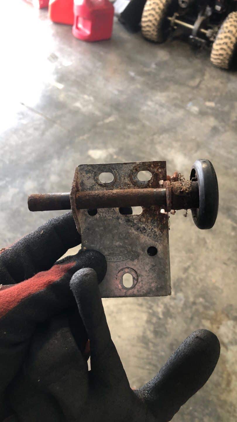 Garage door technician inspecting rollers and tracks