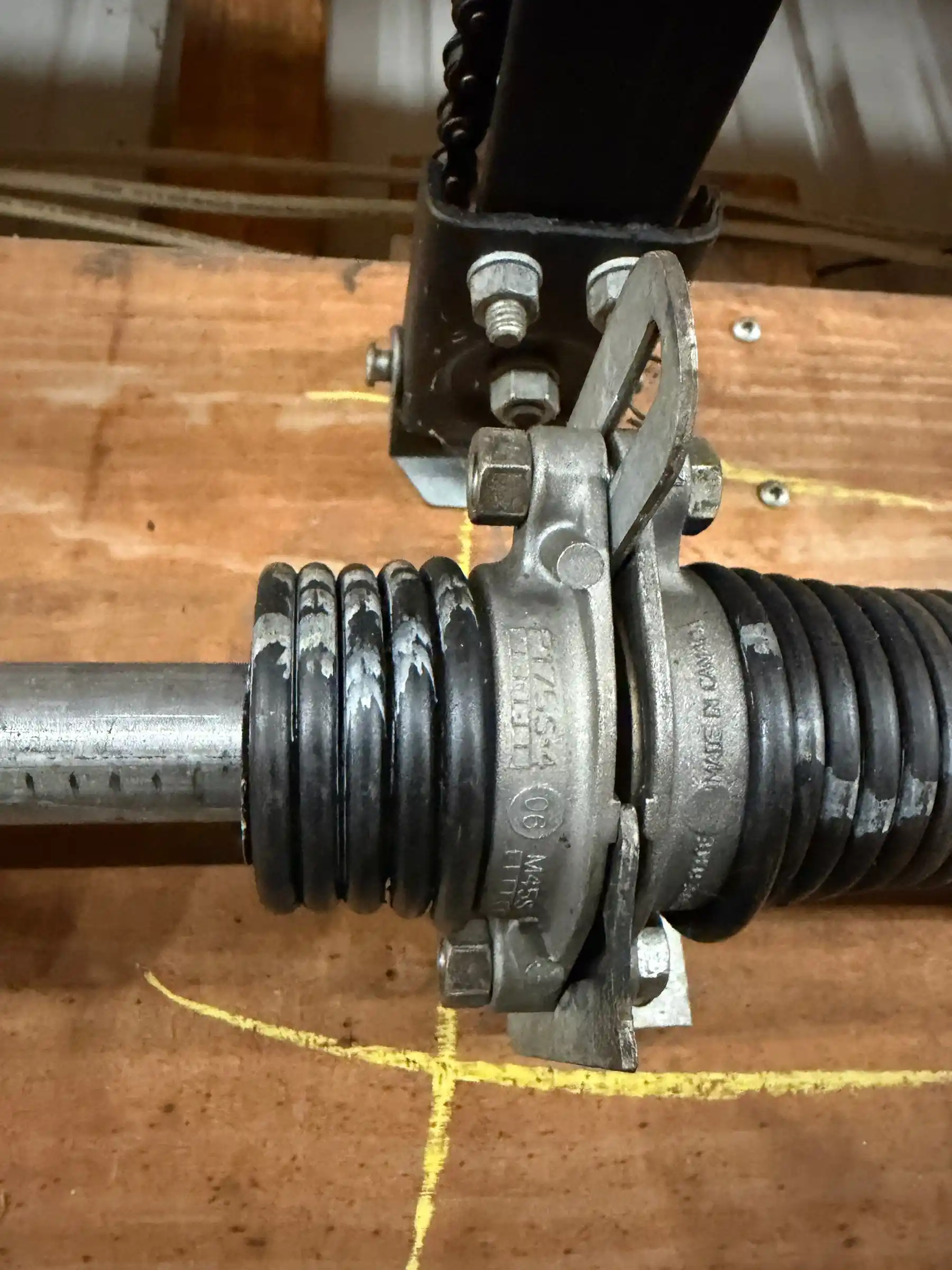 Garage door technician inspecting a residential garage door spring system